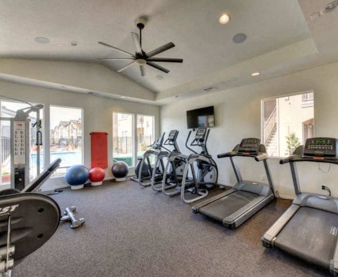 Modern gym fitness room with large windows and treadmills at Eaton Village in Chico, California