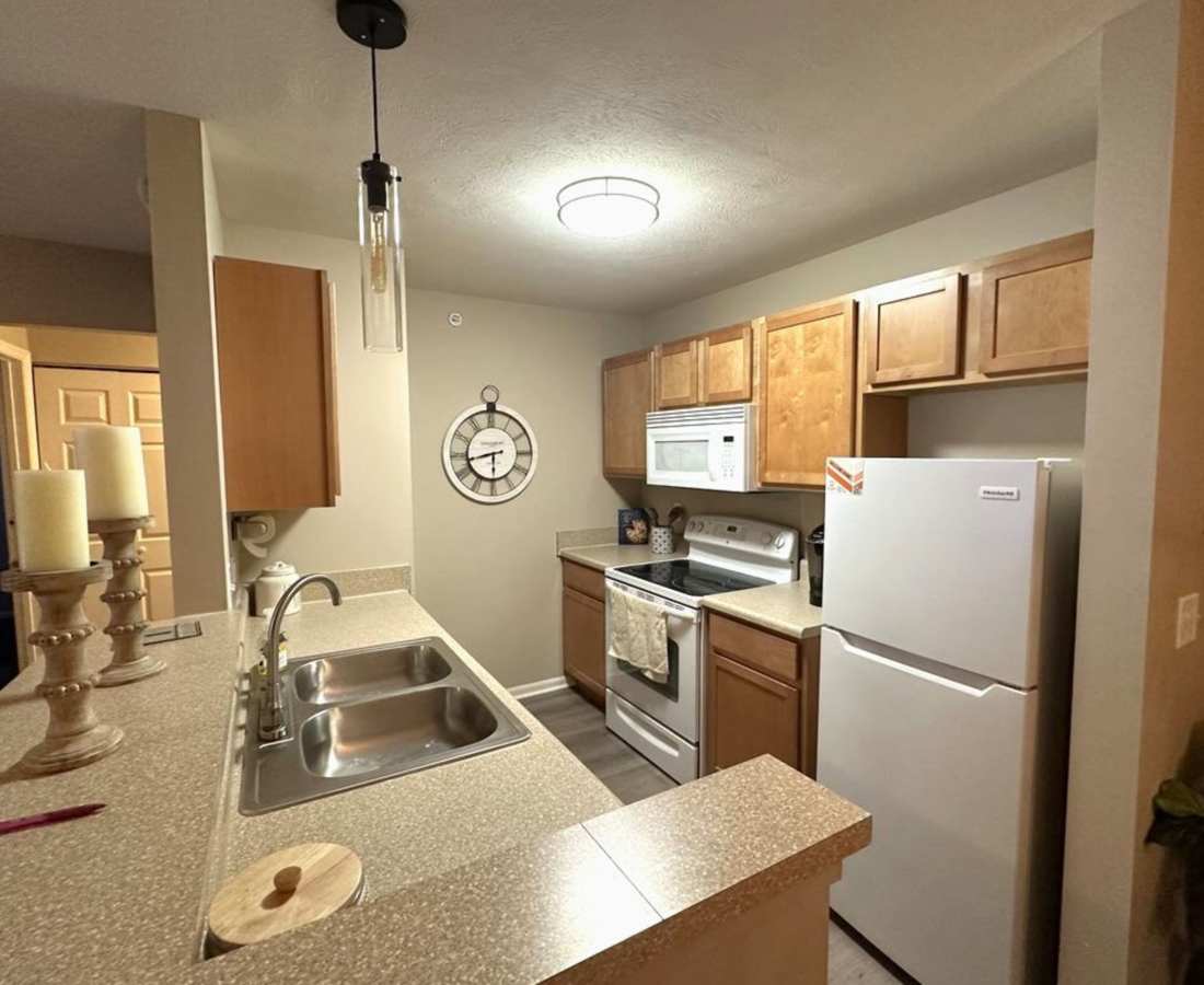 Classically furnished kitchen in a model luxury apartment at Townsend On The Park Apartments in Grand Ledge, Michigan