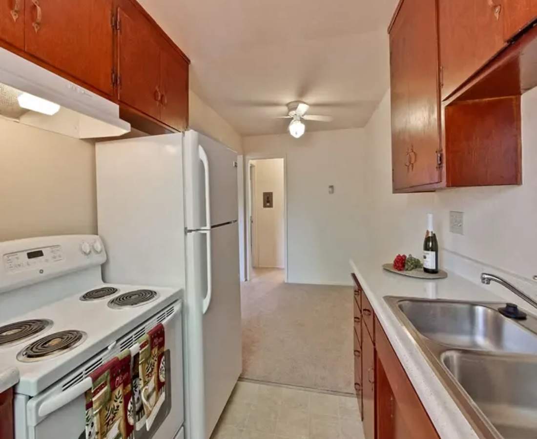 Kitchen with white appliances at Cherry Blossom Apartments in Sunnyvale, California