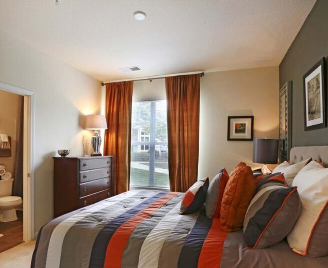 Bedroom with large windows at Preserve at Steele Creek in Charlotte, North Carolina