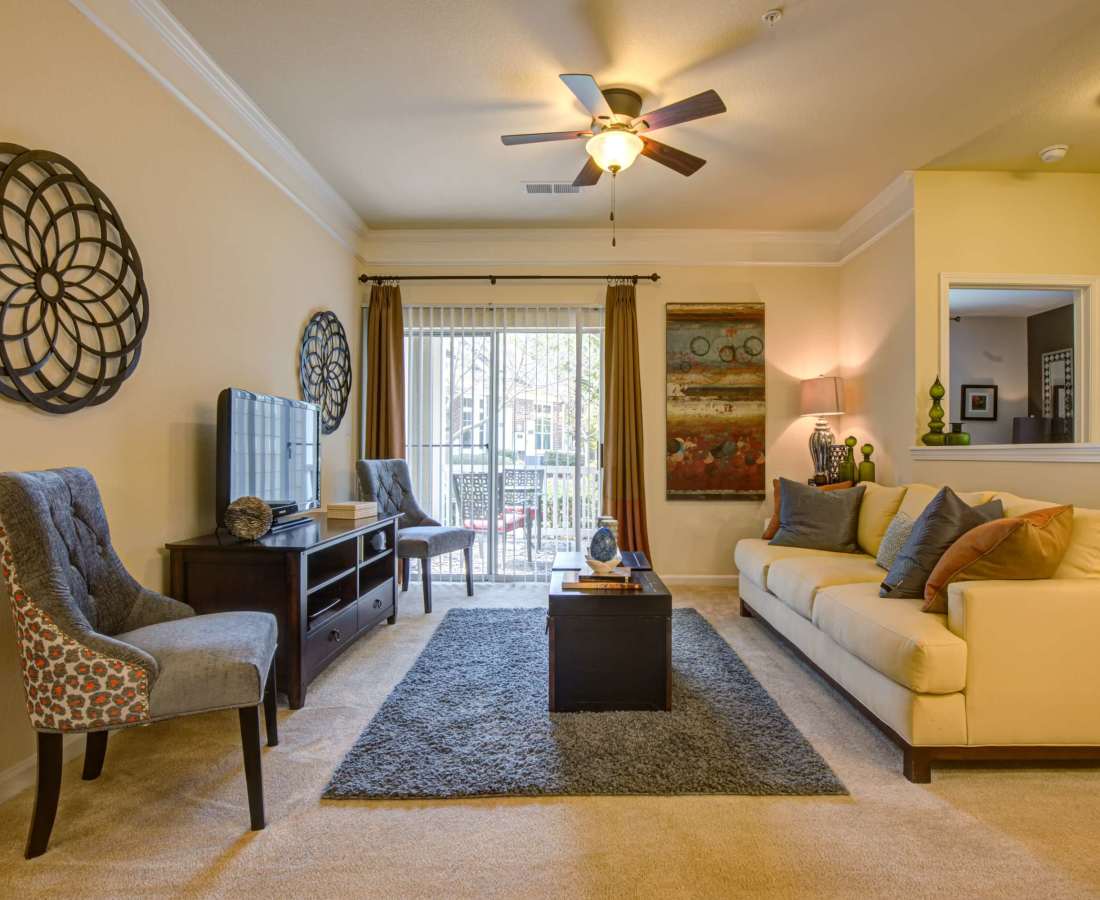 Living space with a ceiling fan at Preserve at Steele Creek in Charlotte, North Carolina