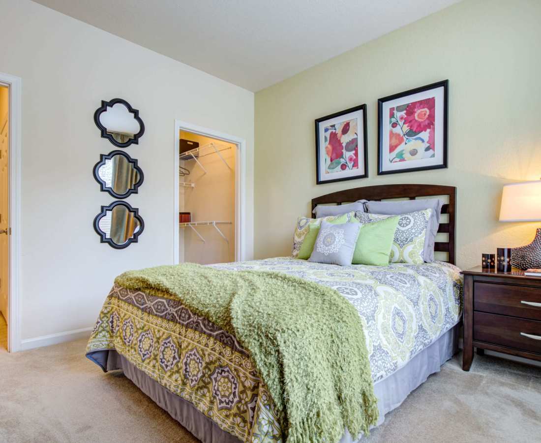 Bedroom with a bed and night stand at Preserve at Steele Creek in Charlotte, North Carolina