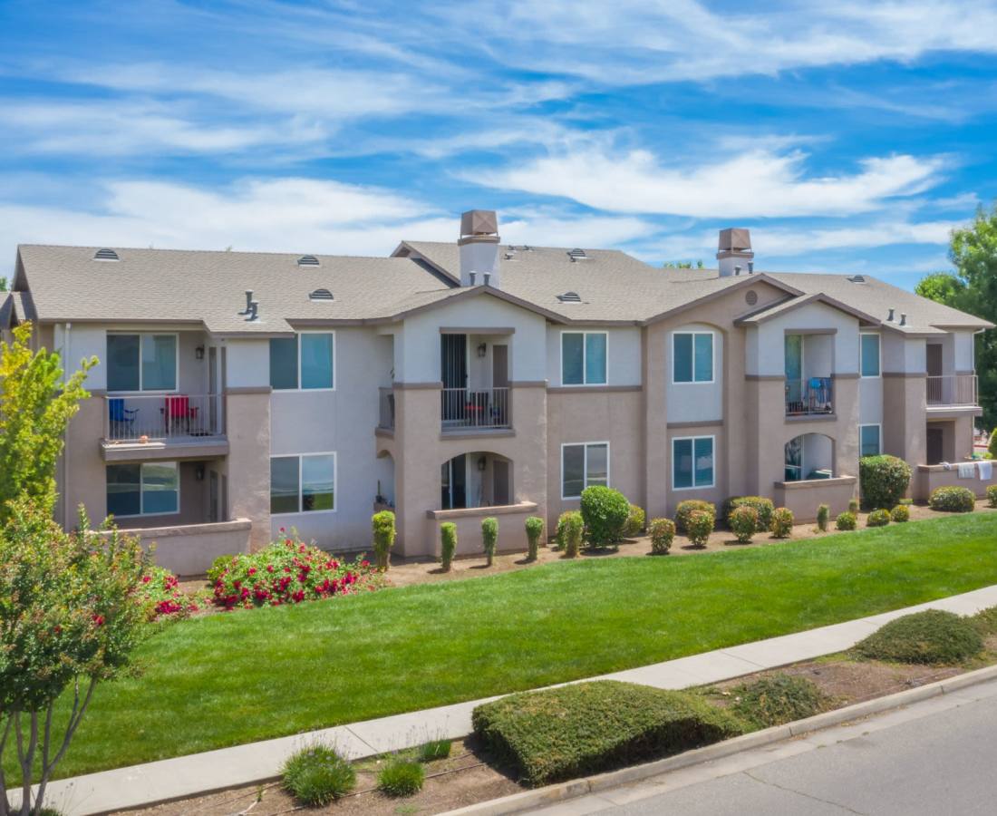 Exterior of an apartment with private patios and balconies at Eaton Village in Chico, California