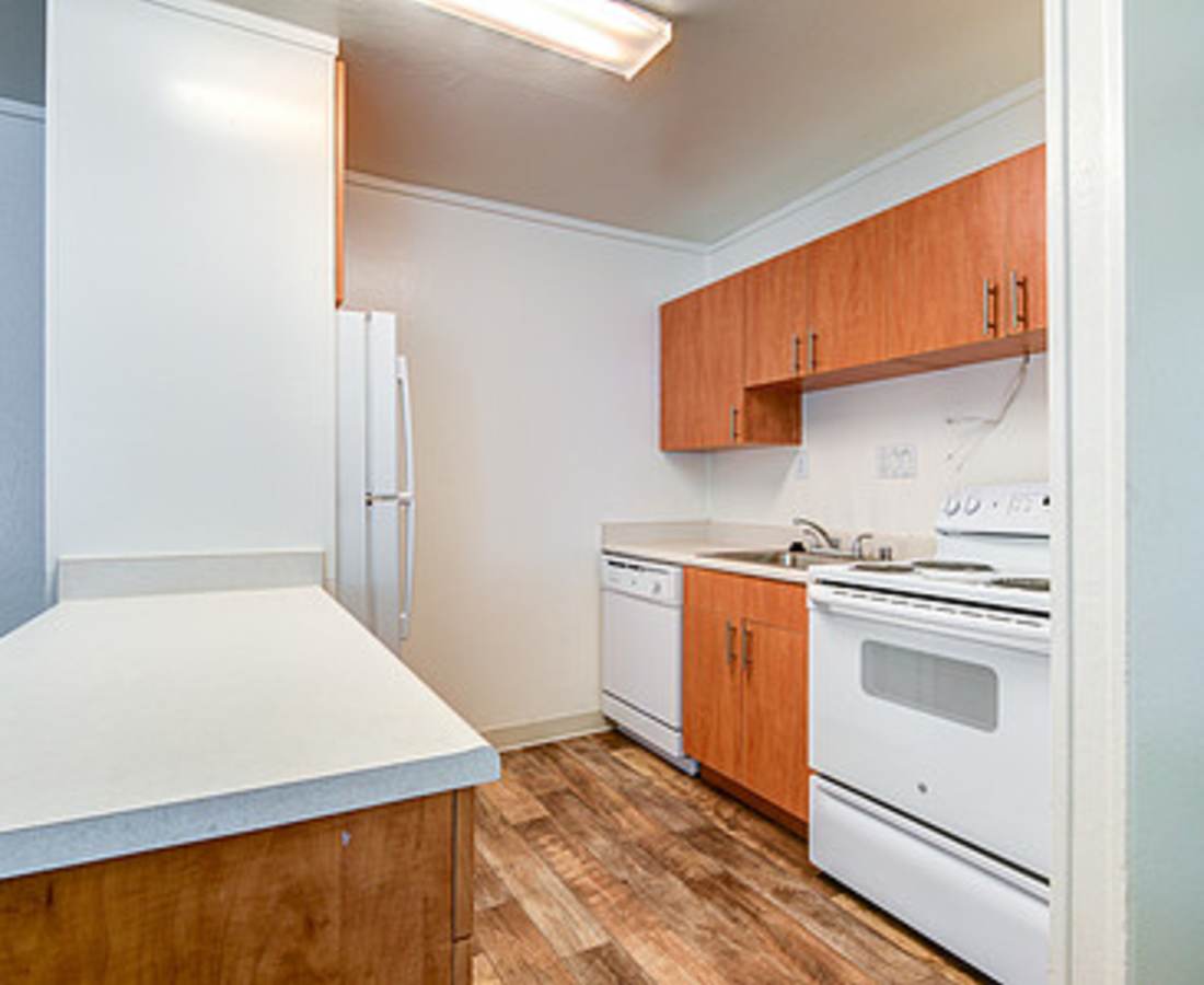 Kitchen with wood-style flooring at Delta View Apartments in Antioch, Californiat