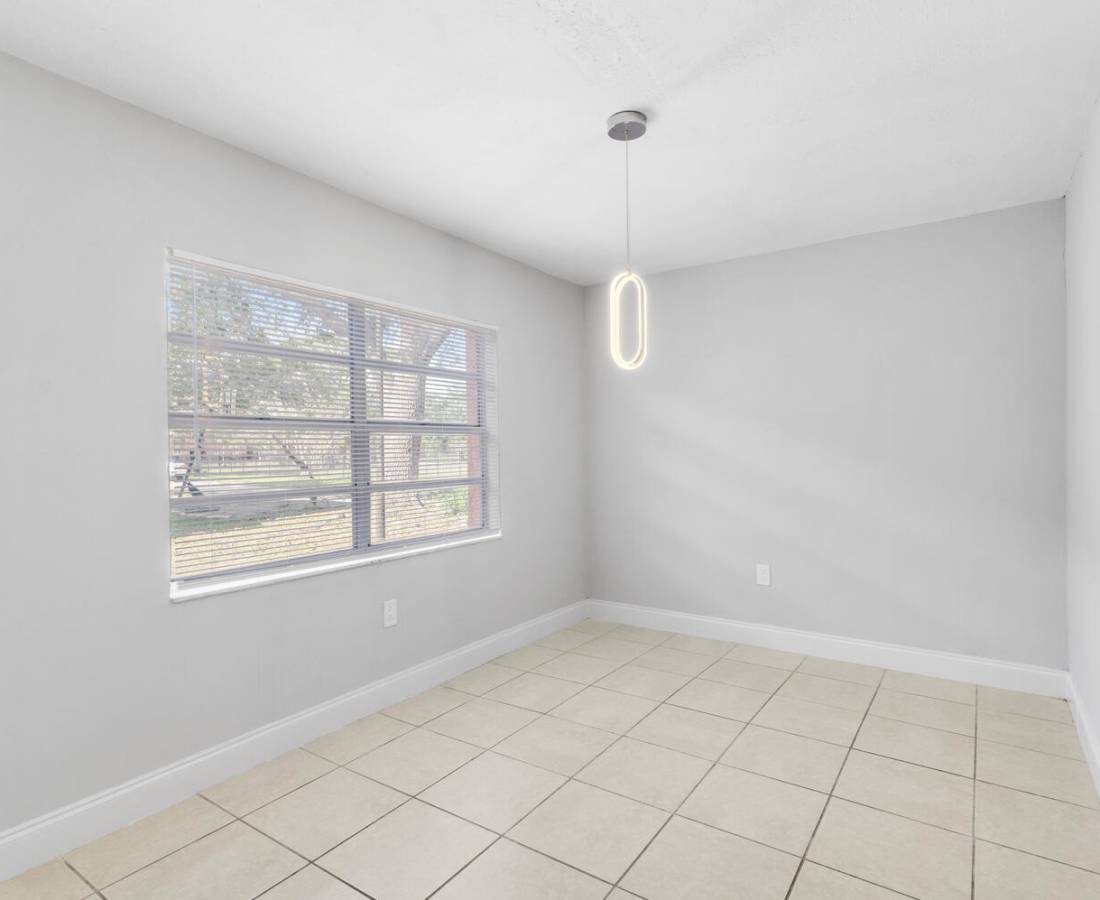 Living room with large window at Palm Bay Club in Palm Bay, Florida