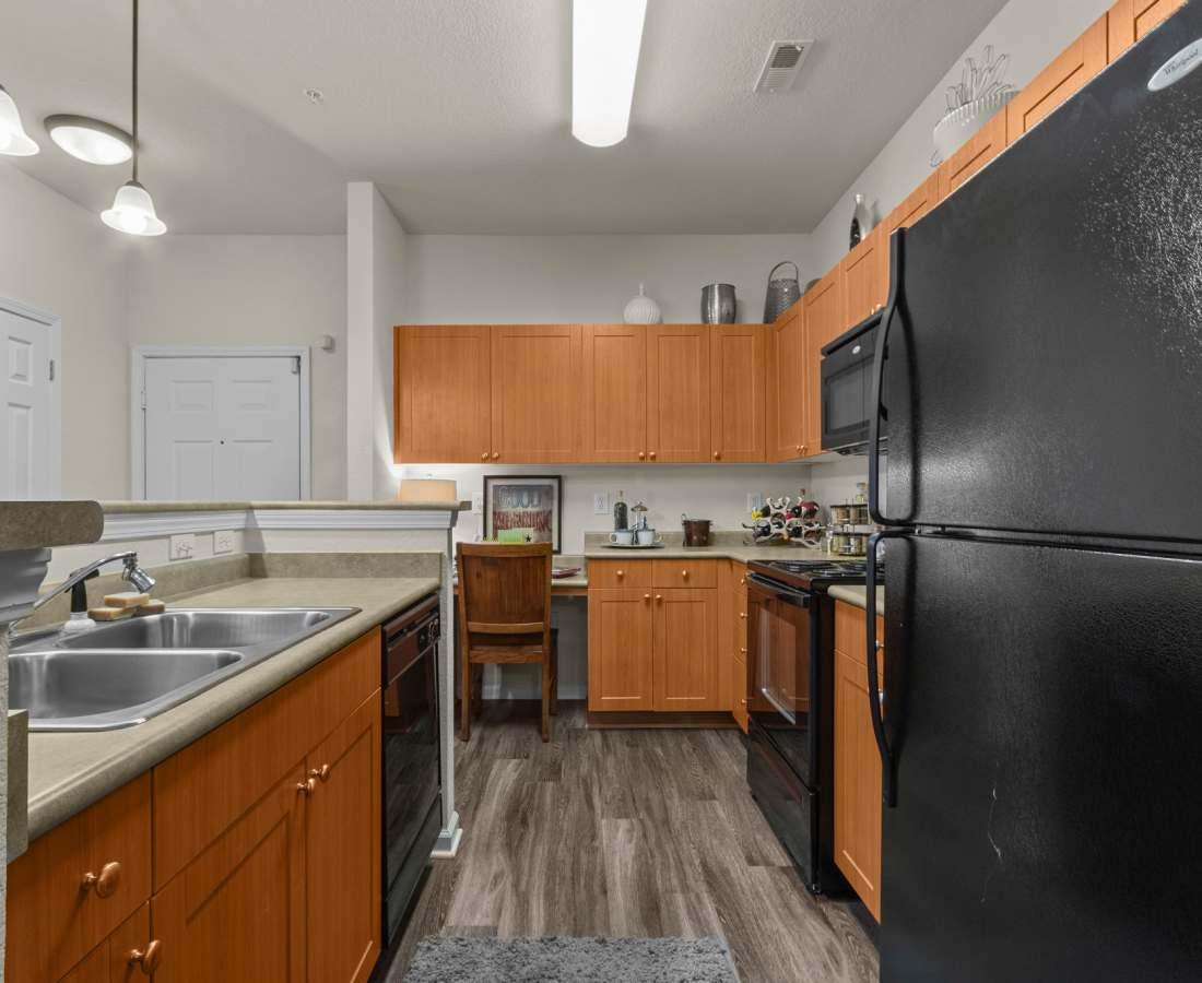 Kitchen with wooden cabinets at Preserve at Steele Creek in Charlotte, North Carolina