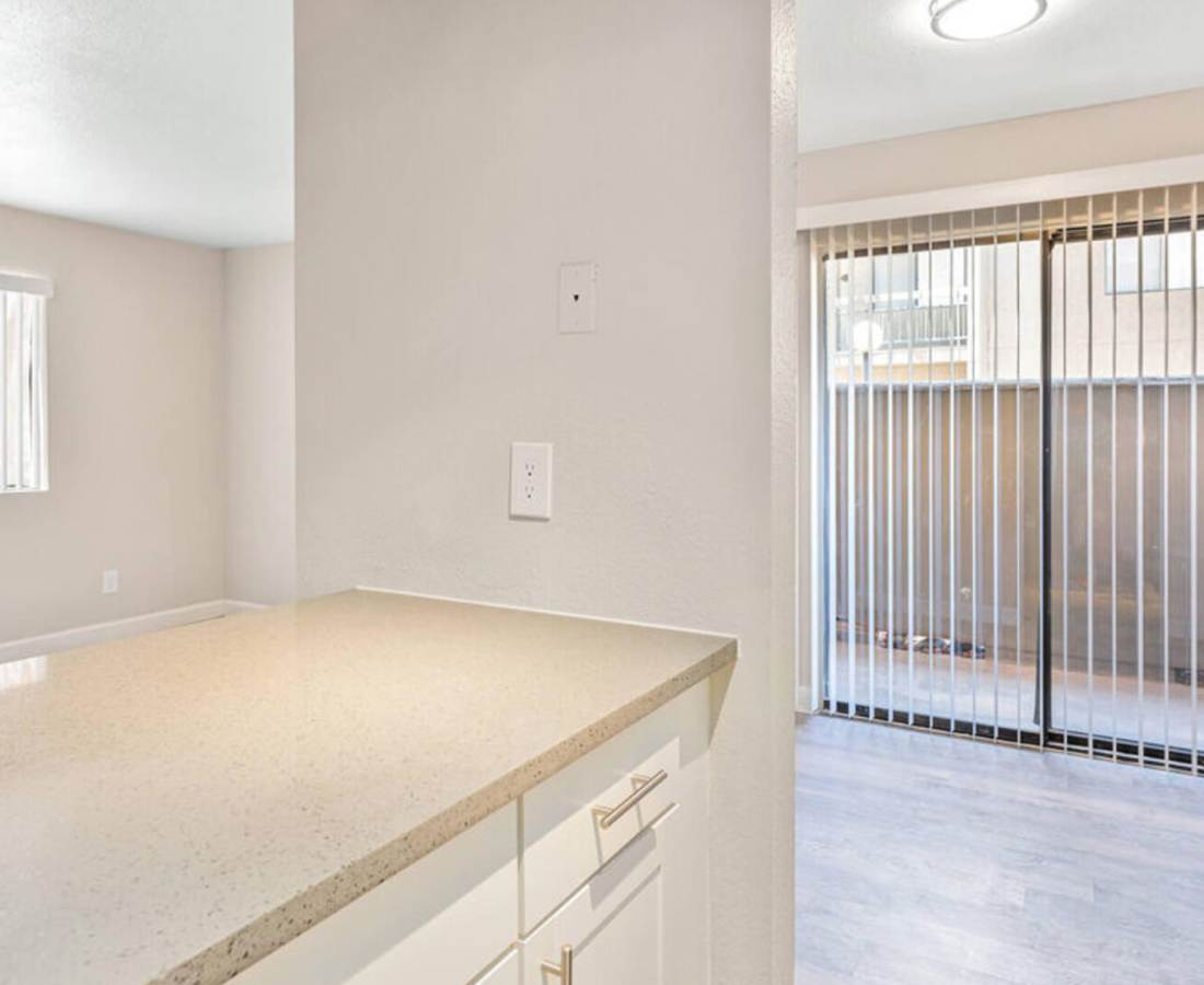 View of Empty living room from kitchen at Raystone Apartments in Phoenix, Arizona