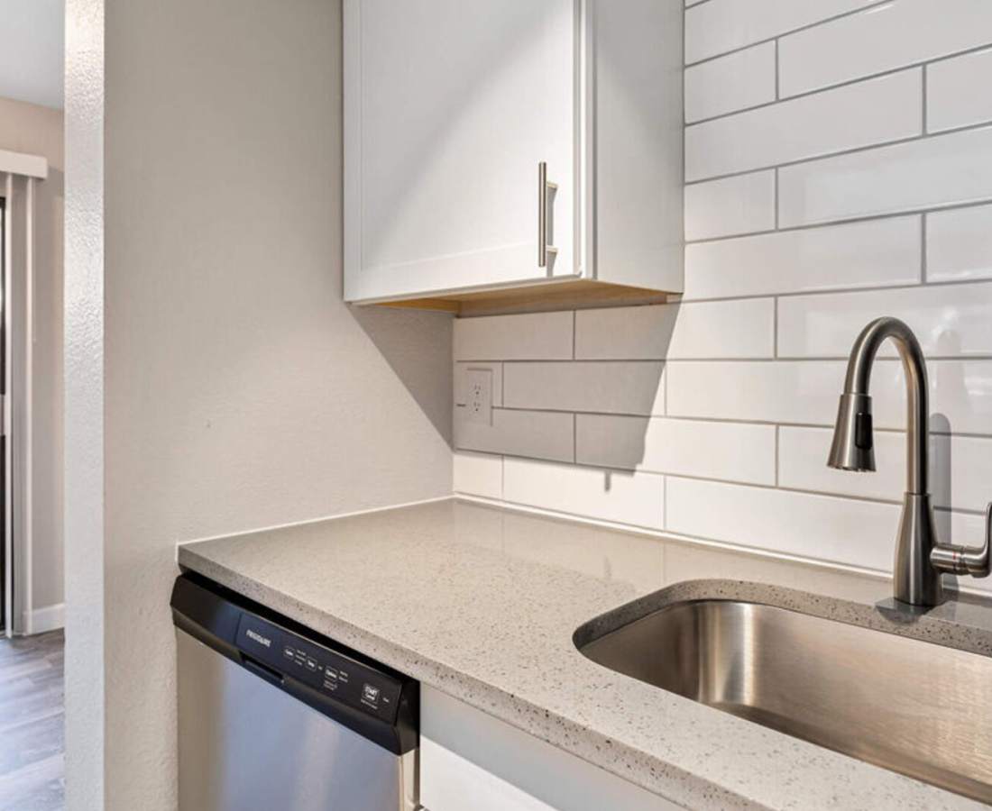 Kitchen with sink and cup board at Raystone Apartments in Phoenix, Arizona