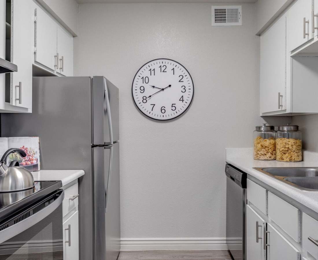 Stylish kitchen with quartz countertops and stainless-steel appliances at 544 Southern Apartments in Mesa, Arizona