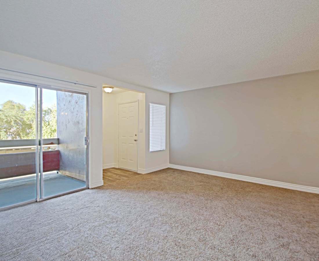 Open layout living with access to balcony through door at 544 Southern Apartments in Mesa, Arizona