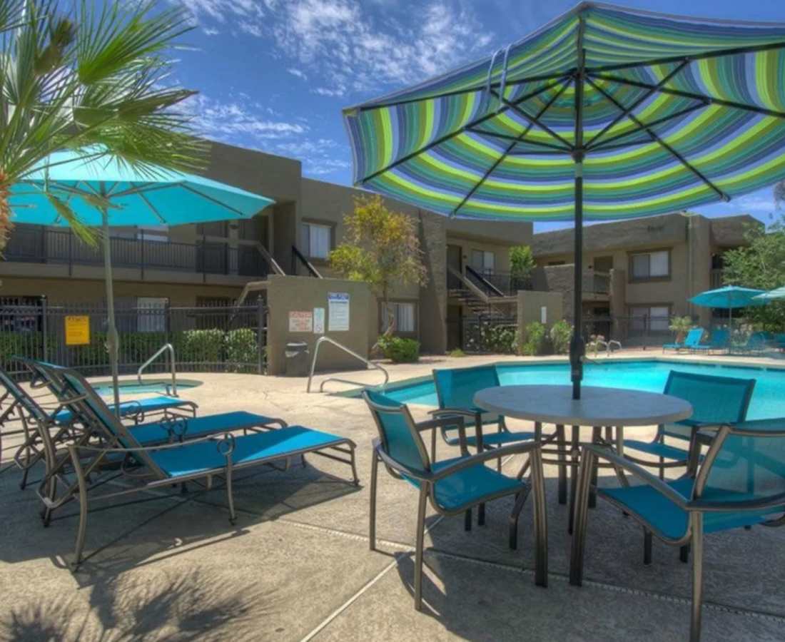 Laid back chairs with shade at Raystone Apartments in Phoenix, Arizona