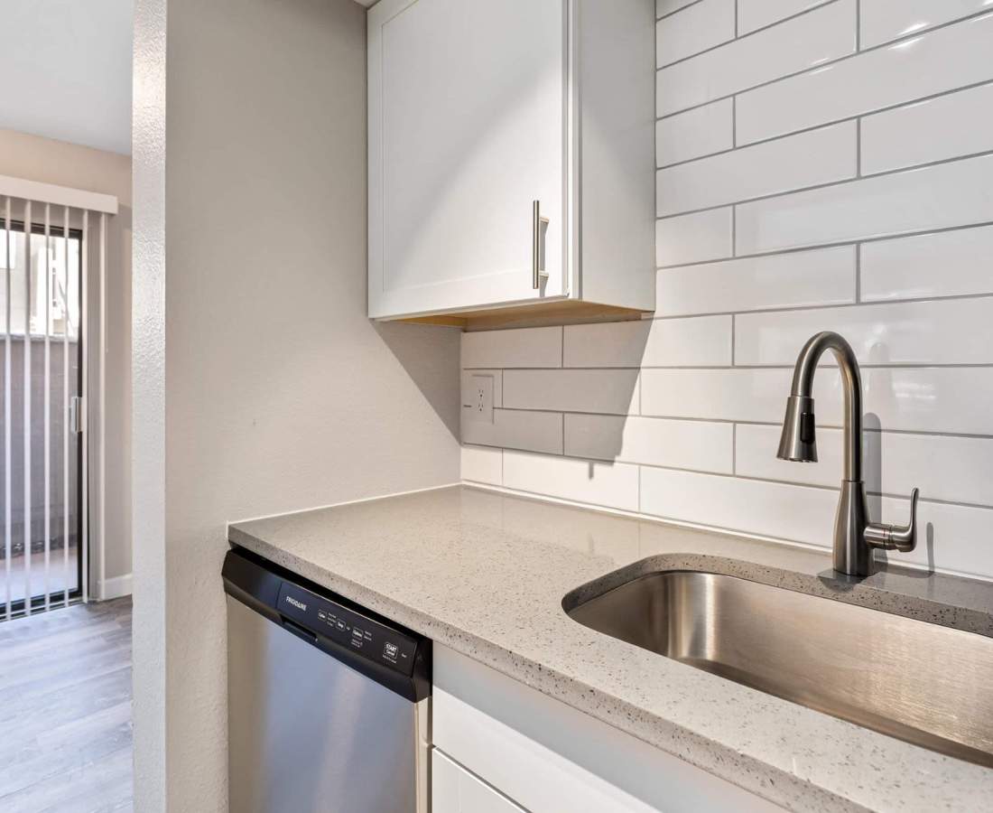 Kitchen with sink and storage space at Raystone Apartments in Phoenix, Arizona