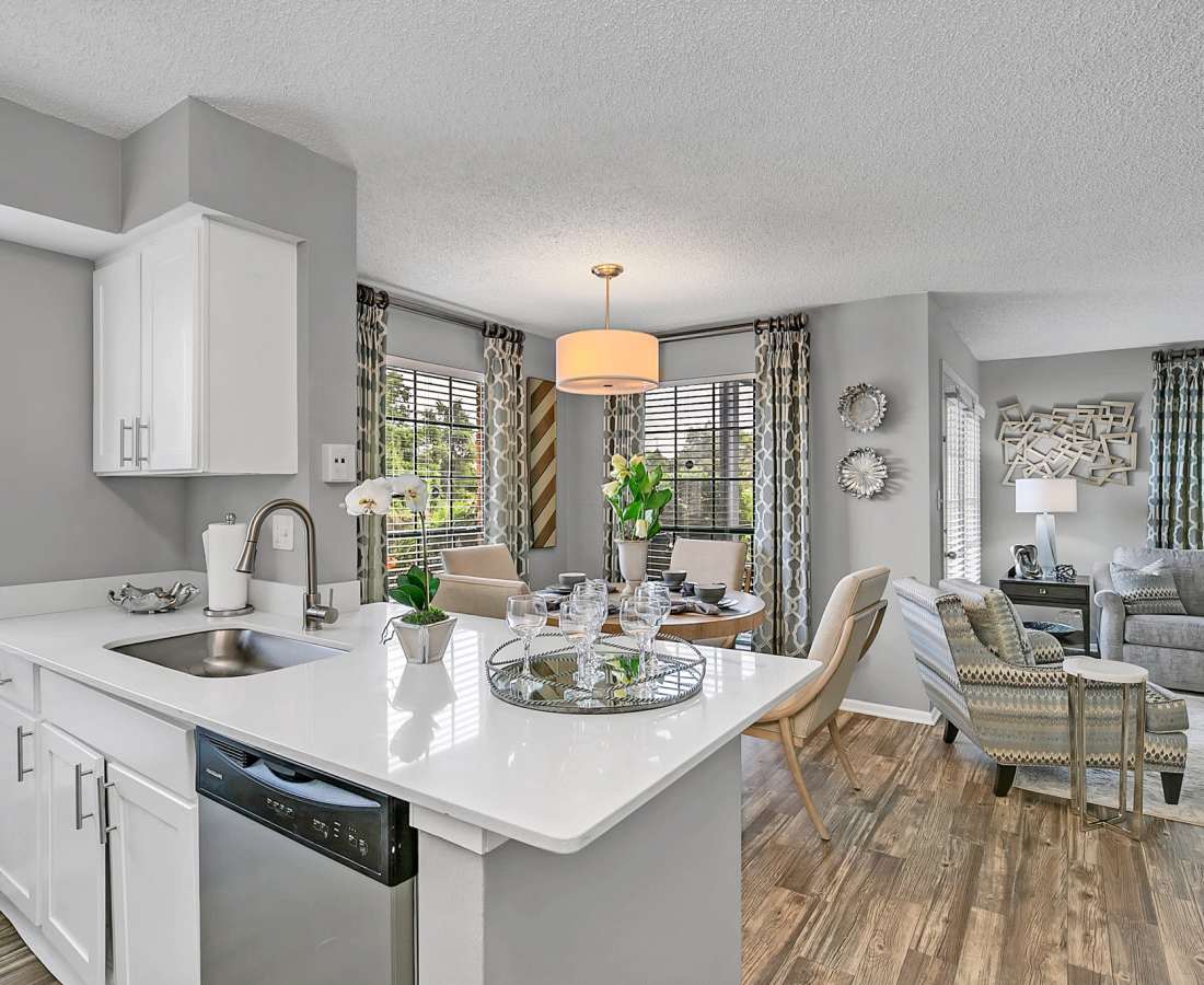 View of the dining table and a living room with a comfortable couch at Rosemont Windermere in Orlando, Florida