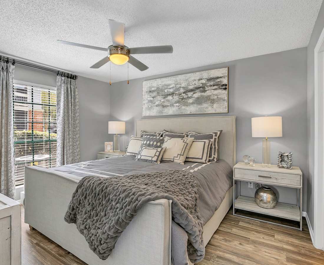 Bedroom with a large window, bed and wooden flooring at Rosemont Windermere in Orlando, Florida