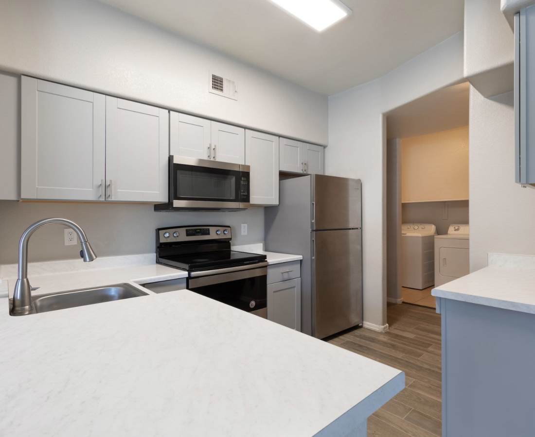 Kitchen with view of washer and dryer at Sol District in Phoenix, Arizona