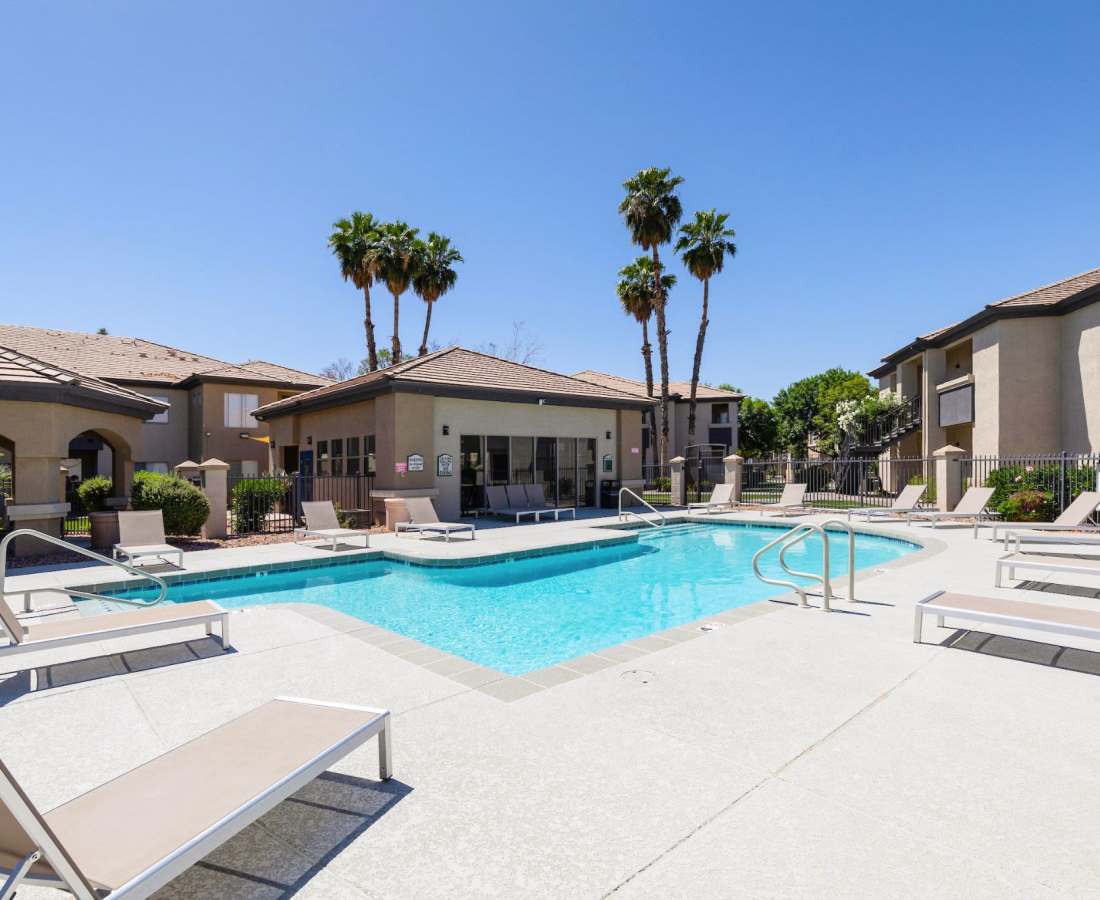 Resort-style swimming pool with background trees at Sol District in Phoenix, Arizona