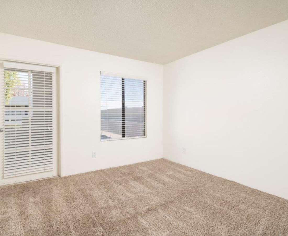 Bedroom with plush carpeting and large windows at Sunpointe in Phoenix, Arizona, 