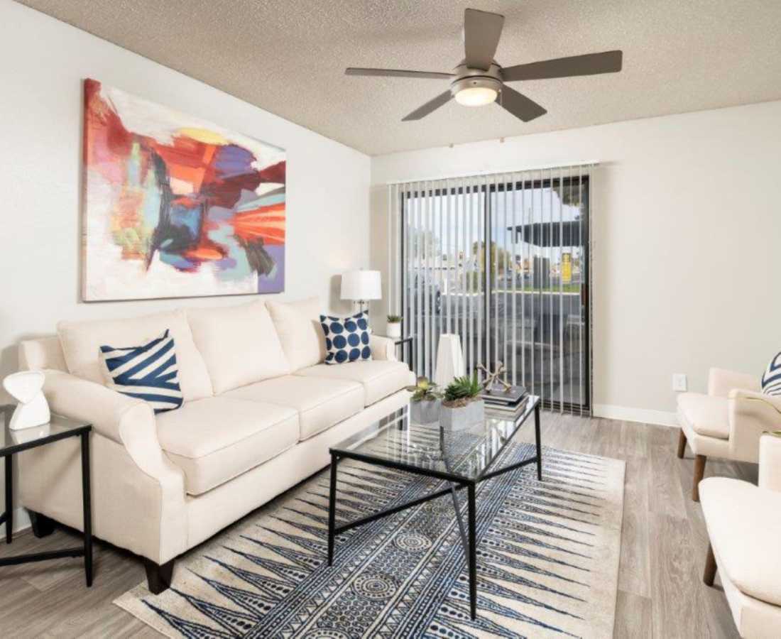Bright living room with access to balcony through glass door at Sunpointe in Phoenix, Arizona, 