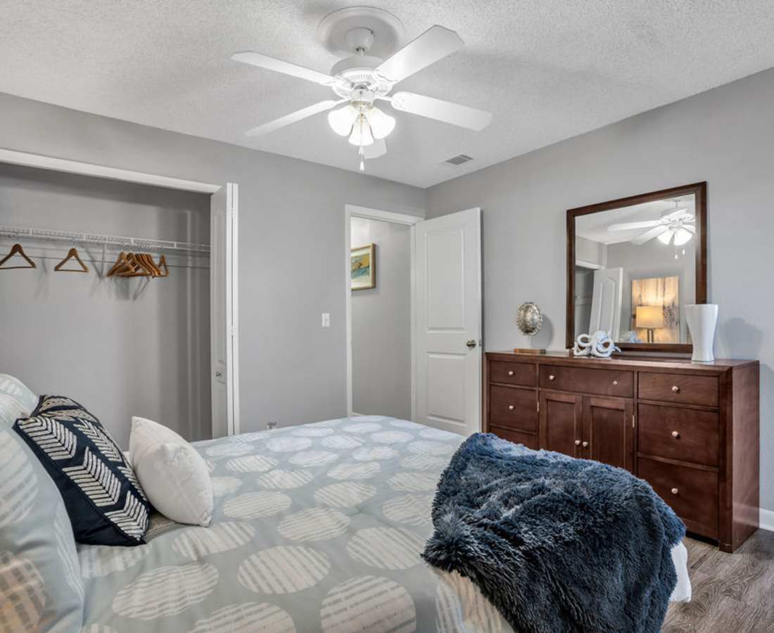 Comfy bedroom with a view of closet at The Canopy Apartment Villas in Orlando, Florida