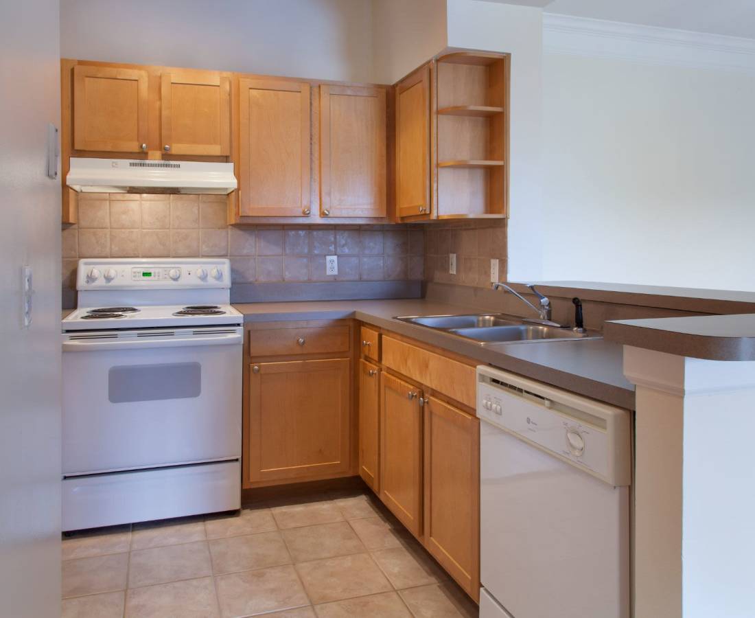 Kitchen with white color appliance at The Legends At ChampionsGate in ChampionsGate, Florida 