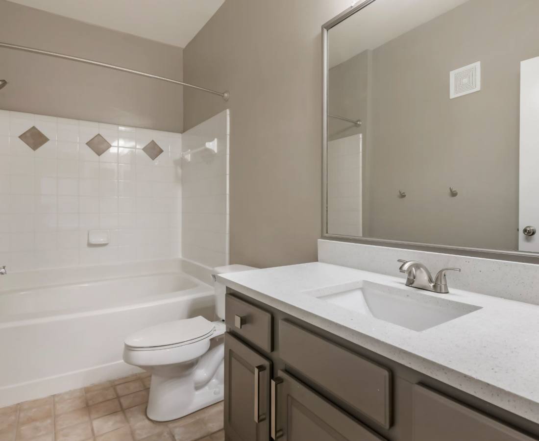 Bathroom with dark color cabinets at The Legends At ChampionsGate in ChampionsGate, Florida