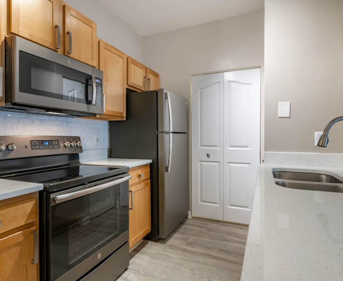 Kitchen with black color appliance at The Legends At ChampionsGate in ChampionsGate, Florida