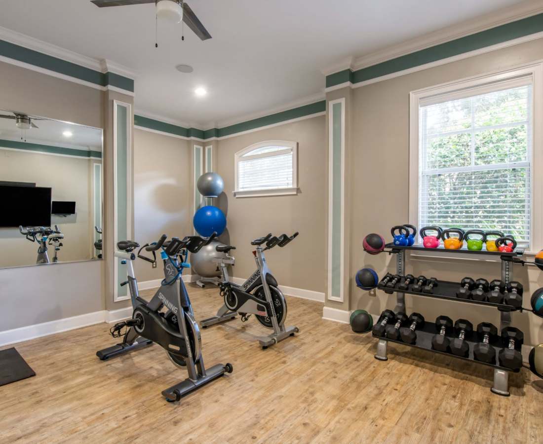 Fitness center with dumb bells at The Legends At ChampionsGate in ChampionsGate, Florida