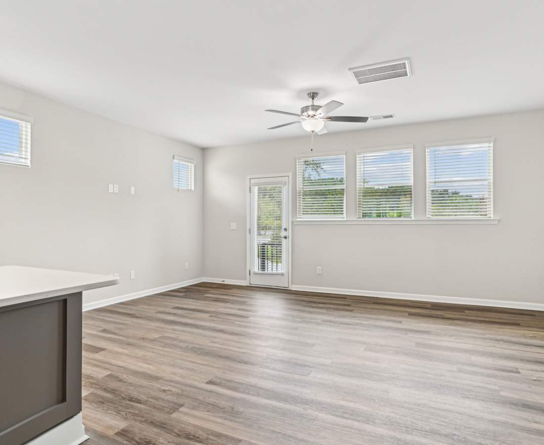 Spacious living room with ceiling fan and window at Westmont Village in Charlotte, North Carolina