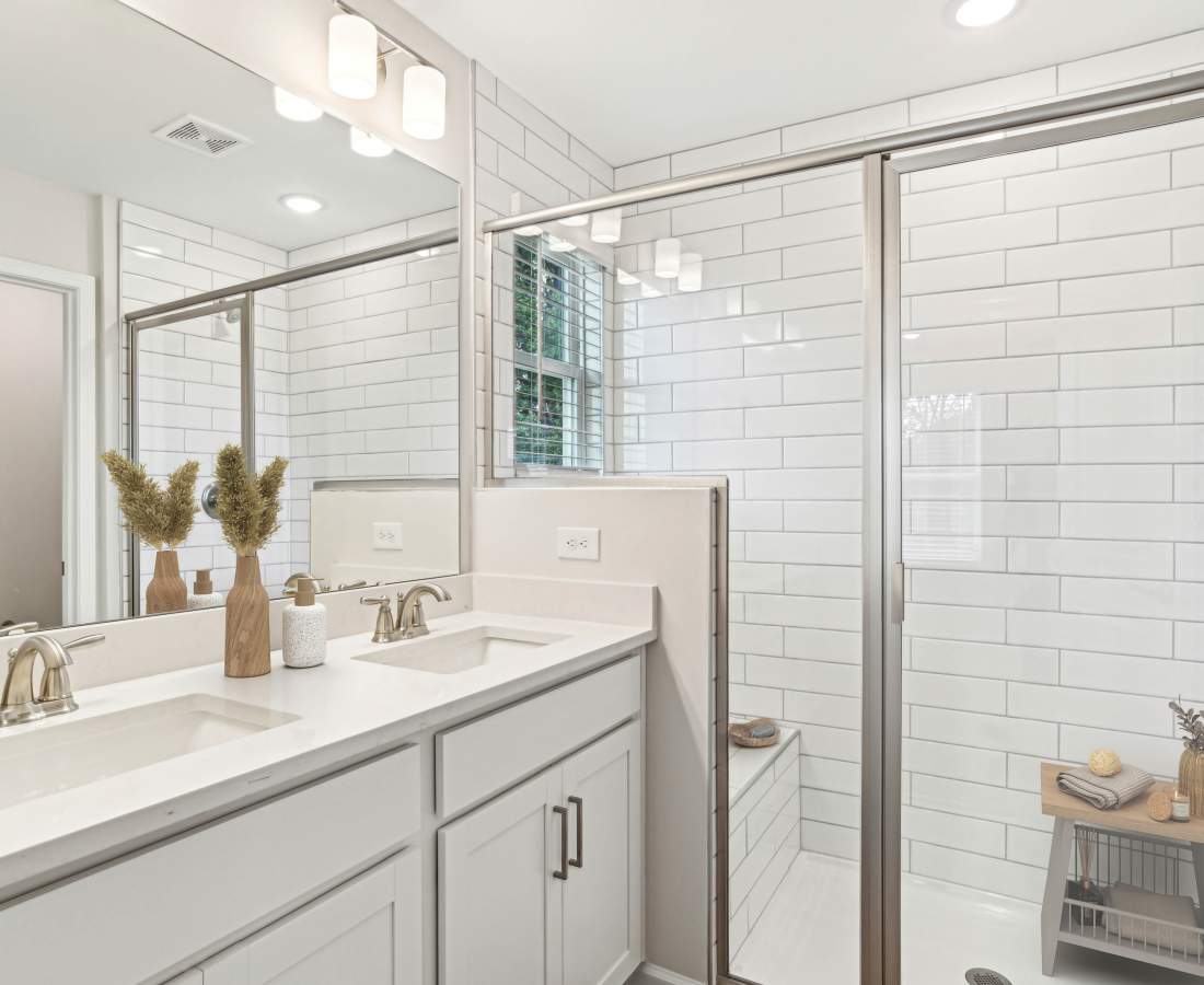 Bathroom with tiled wall, sink and mirror at Westmont Village in Charlotte, North Carolina