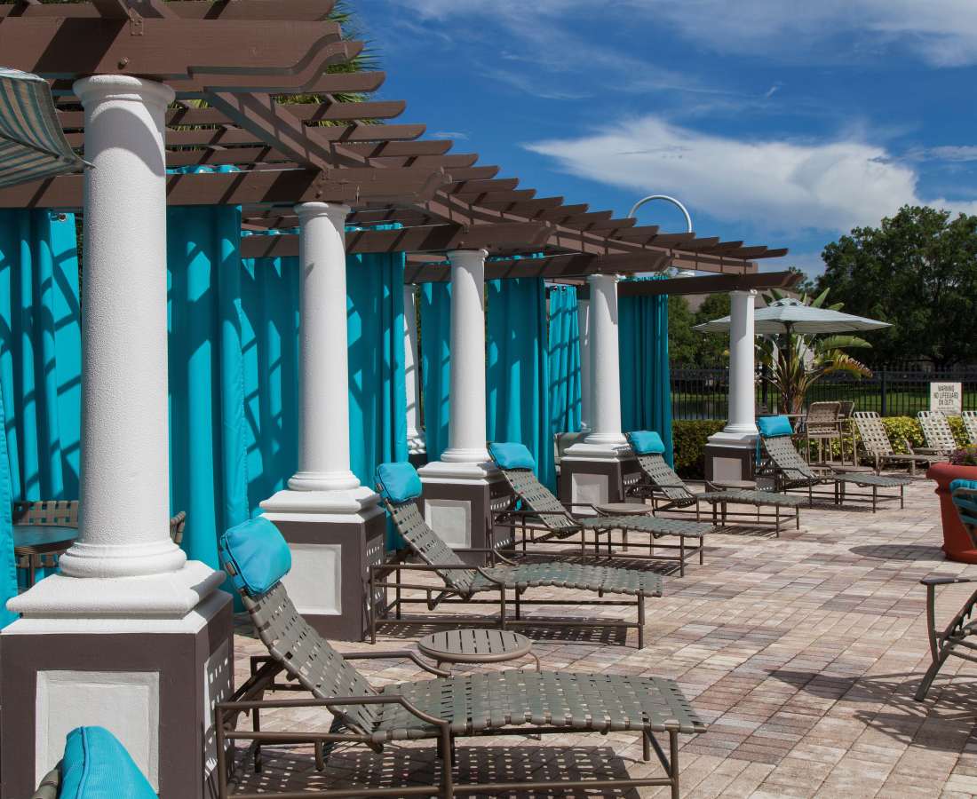 Sun loungers by the pool at The Legends At ChampionsGate in ChampionsGate,Florida