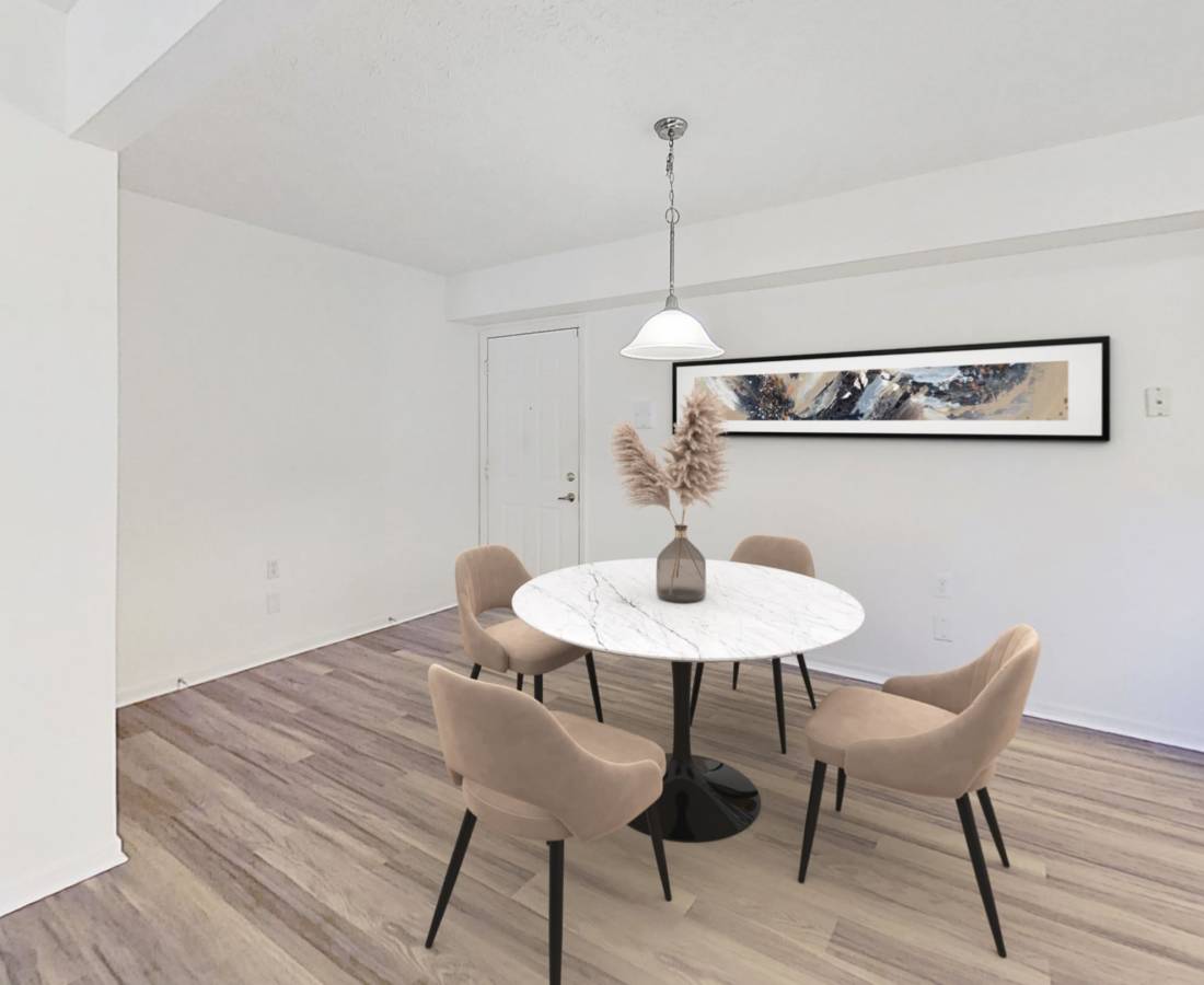 Bar seating and conference tables and chairs in the clubhouse lounge at Springbrook Meadows Apartments in Jackson, Michigan