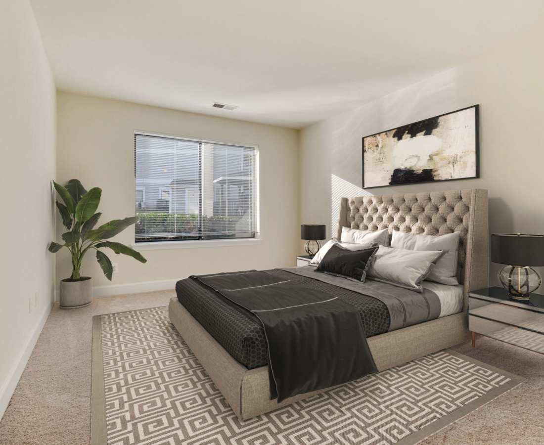 Bed is made with decorative pillows at Bethesda Hill in Bethesda, Maryland