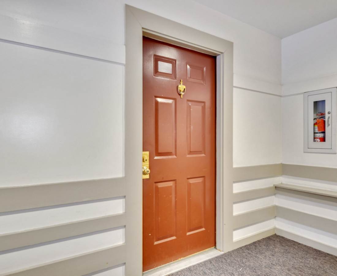 Brown door with a gold doorknob at Bethesda Hill in Bethesda, Maryland