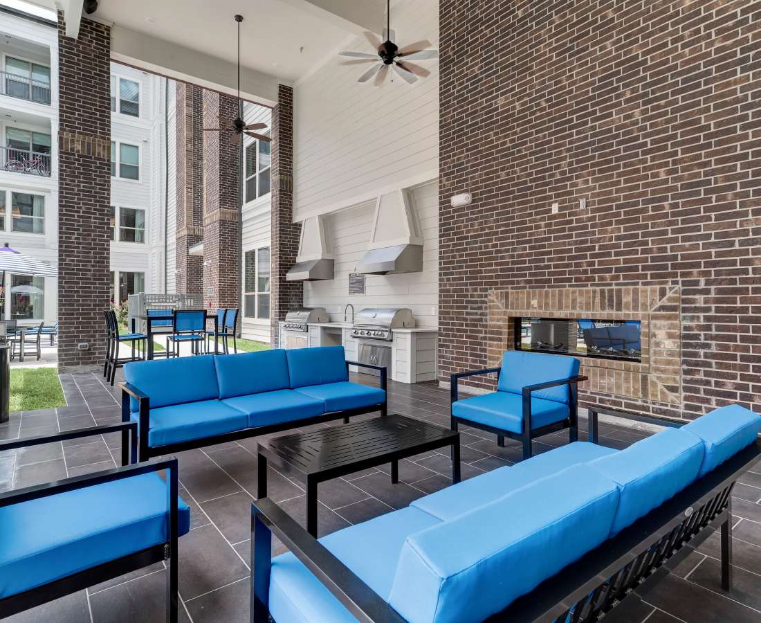 Blue seating area with a fireplace at Dakota at Shepherd in Houston, Texas