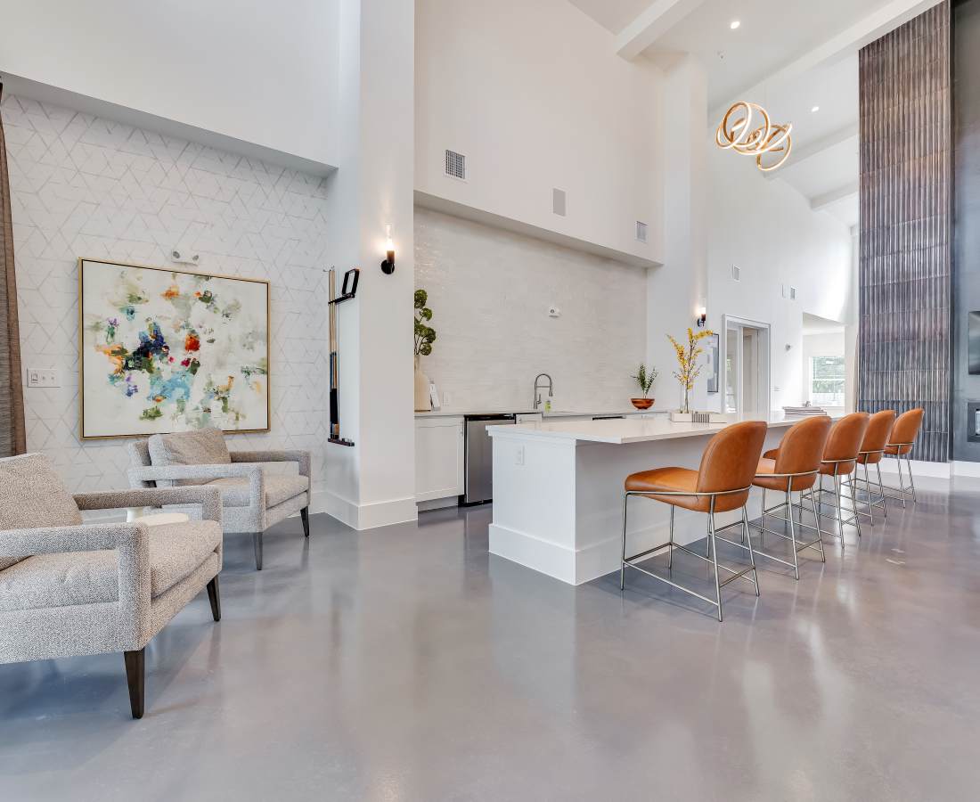 Bright kitchen island with seating at community at Meridian City Park in Houston, Texas
