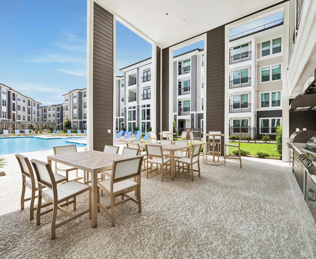 Shaded seating area near pool side at Dakota at Hillcroft in Houston, Texas