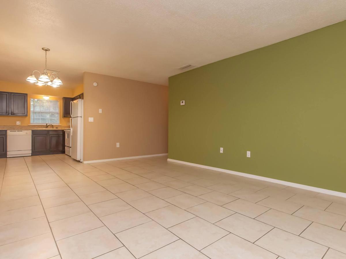 Spacious living room with view to kitchen at Serenity Apartments in Leesburg, Florida