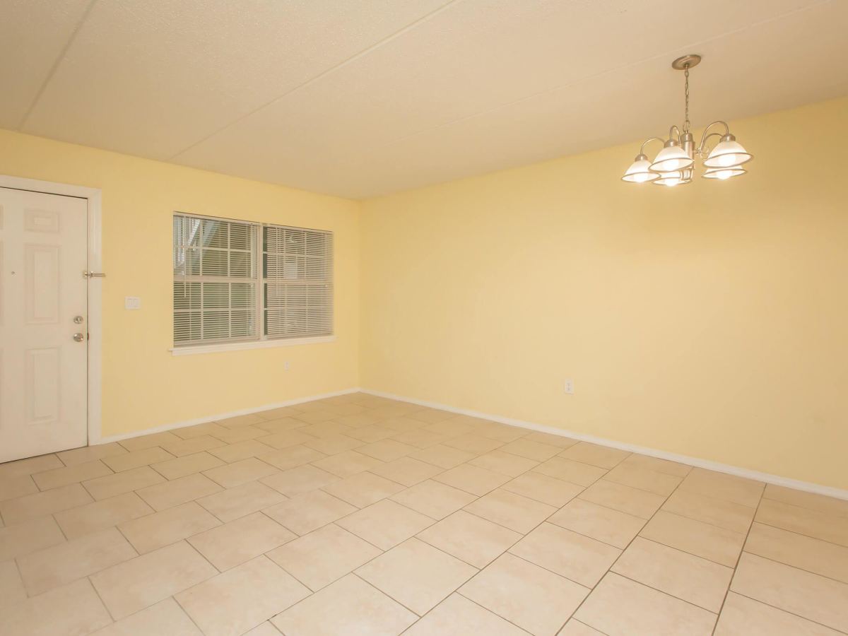 Bedroom with ceiling light, window and door at Serenity Apartments in Leesburg, Florida