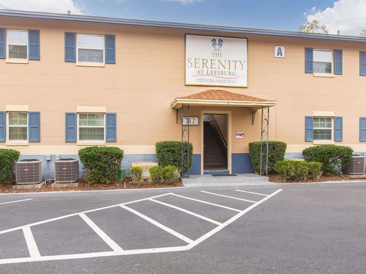 Apartment entry with parking place at Serenity Apartments in Leesburg, Florida