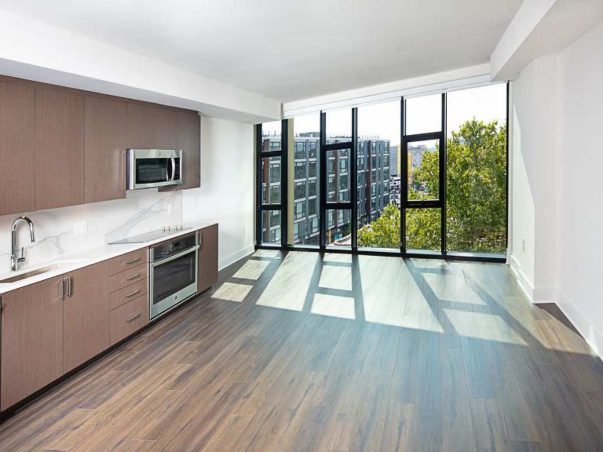 Stainless-steel appliances and large windows in an apartment at J Linea in Washington, District of Columbia