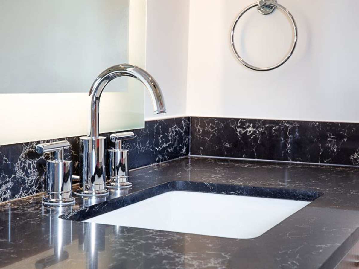 Modern bathroom with dark countertops at J Linea in Washington, District of Columbia