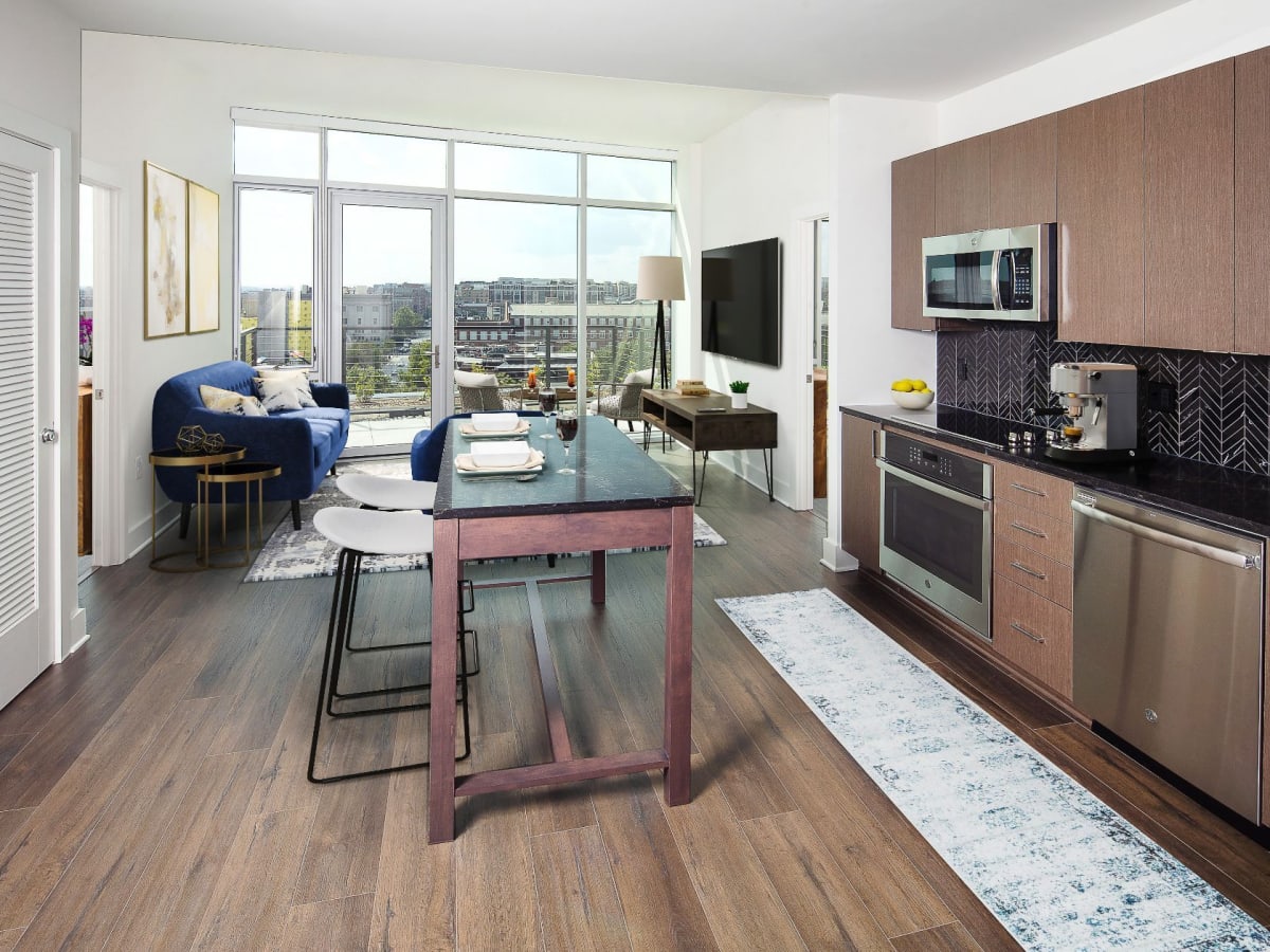 Kitchen with an island and furnished living room at J Linea in Washington, District of Columbia