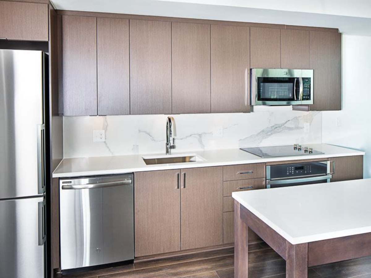 Stainless-steel appliances and an island in a kitchen at J Linea in Washington, District of Columbia