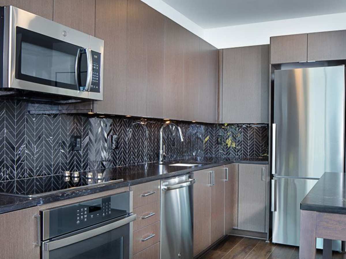Stainless-steel appliances and a tile backsplash at J Linea in Washington, District of Columbia