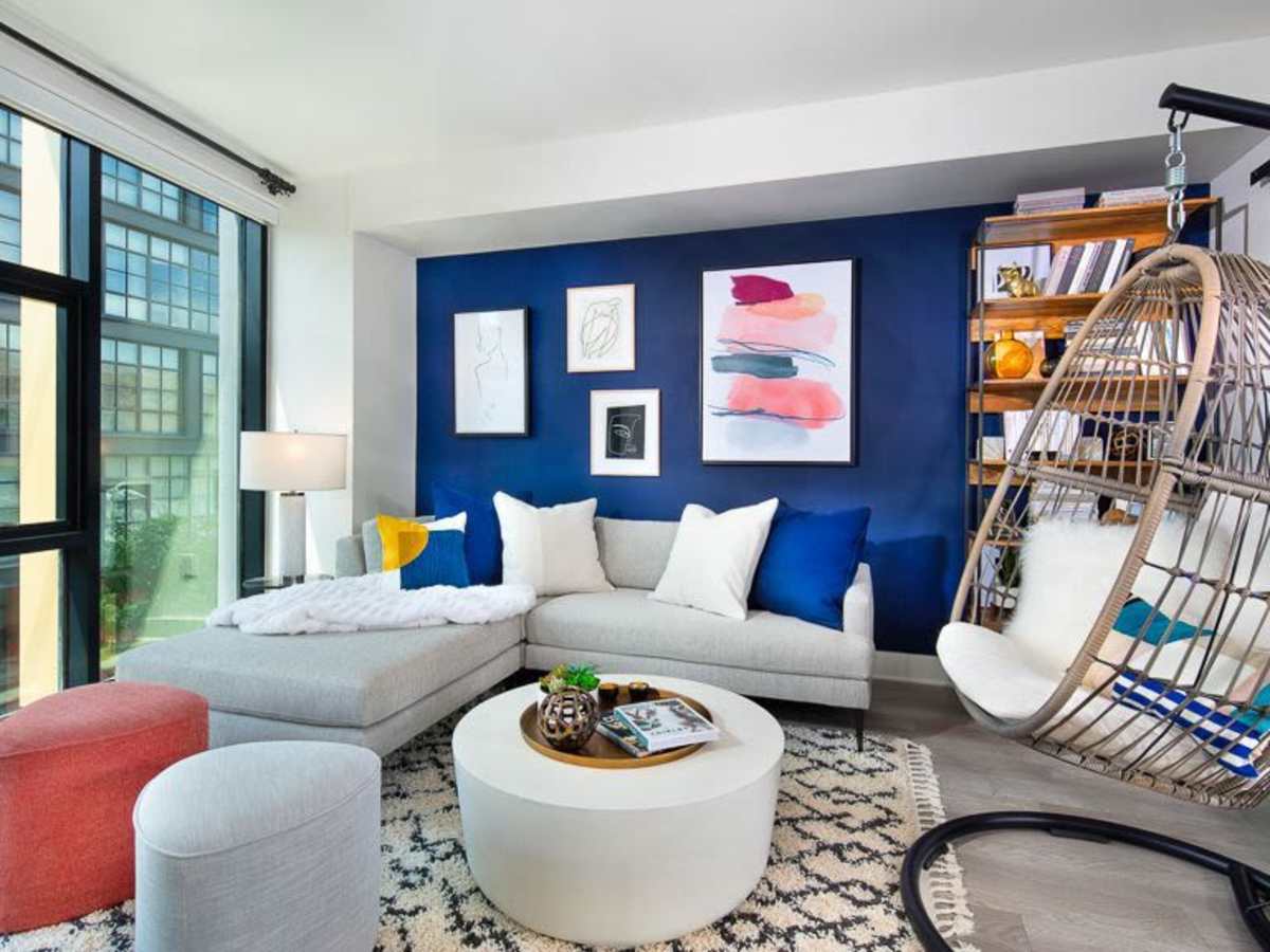 Living room with a blue accent wall at J Linea in Washington, District of Columbia
