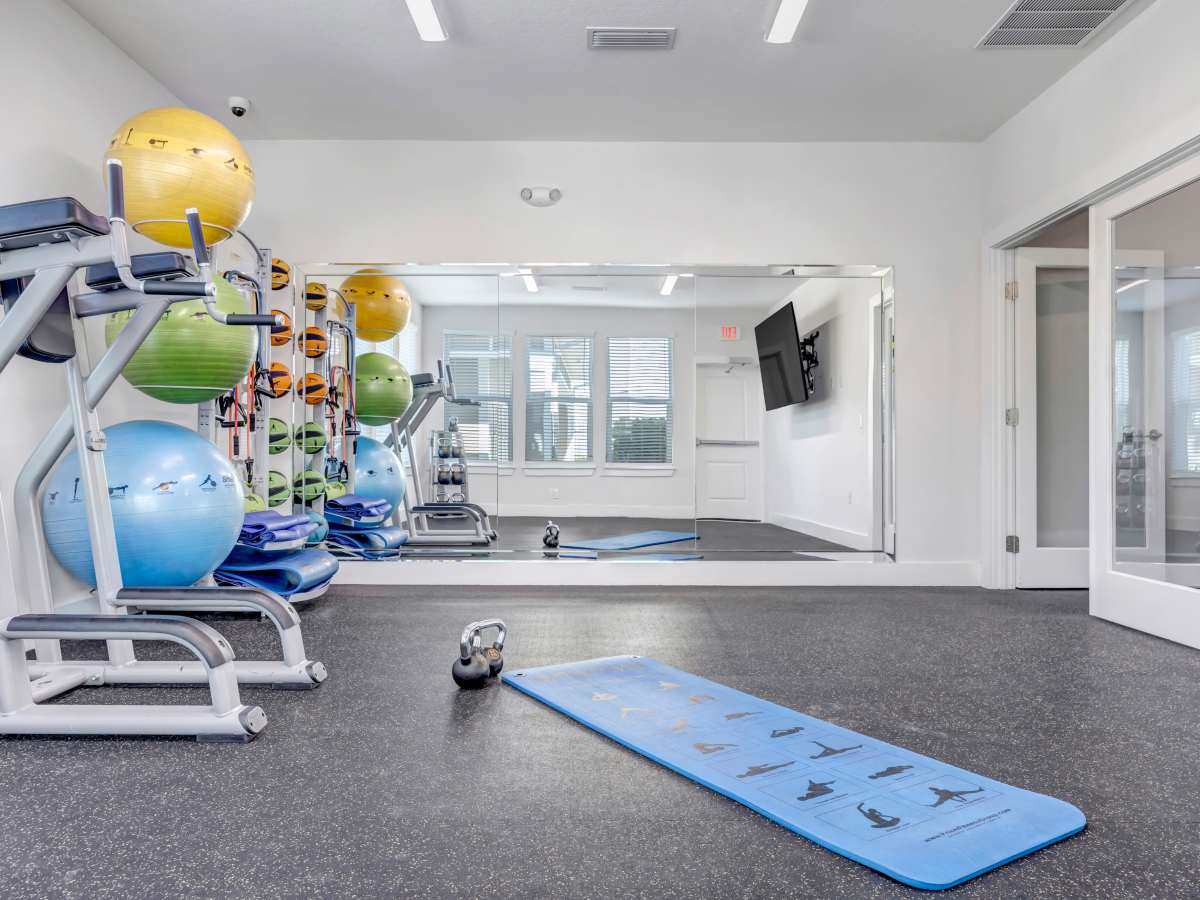 Fitness center with exercise balls at The Carlton of Fort Myers in Fort Myers, Florida