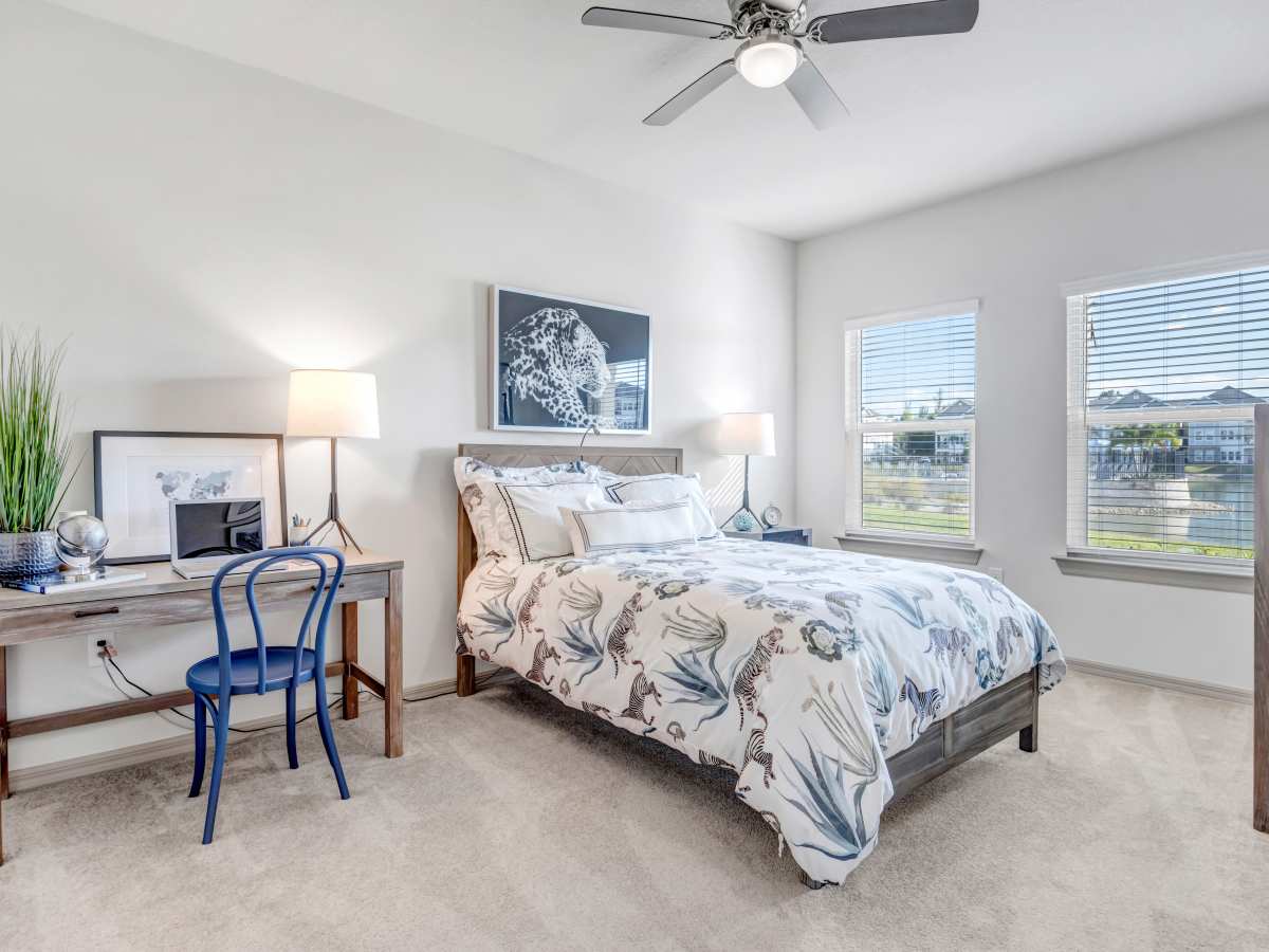 Bedroom of an apartment with ceiling fan at The Carlton of Fort Myers in Fort Myers, Florida