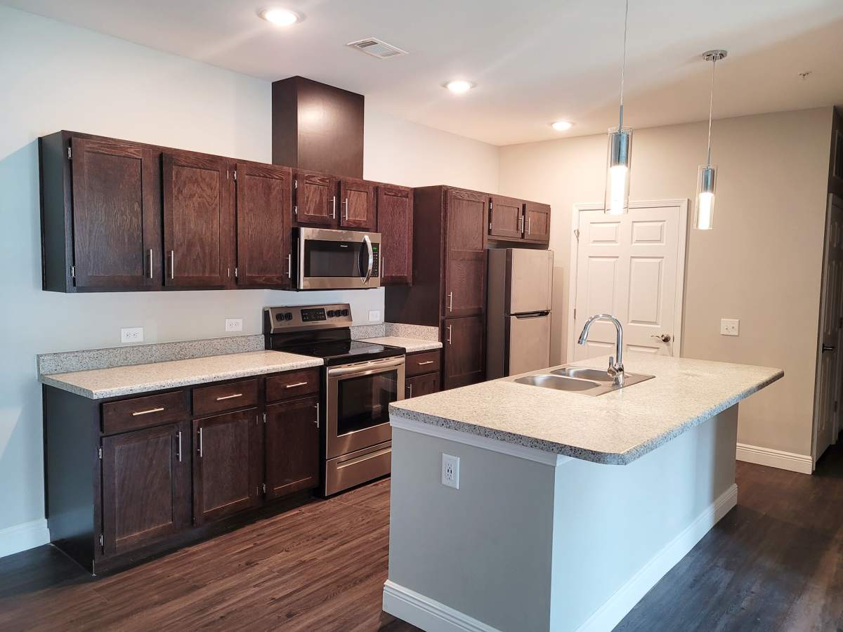 Modern kitchen with wooden cabinets at Seacoast Apartments in St Marys, Georgia