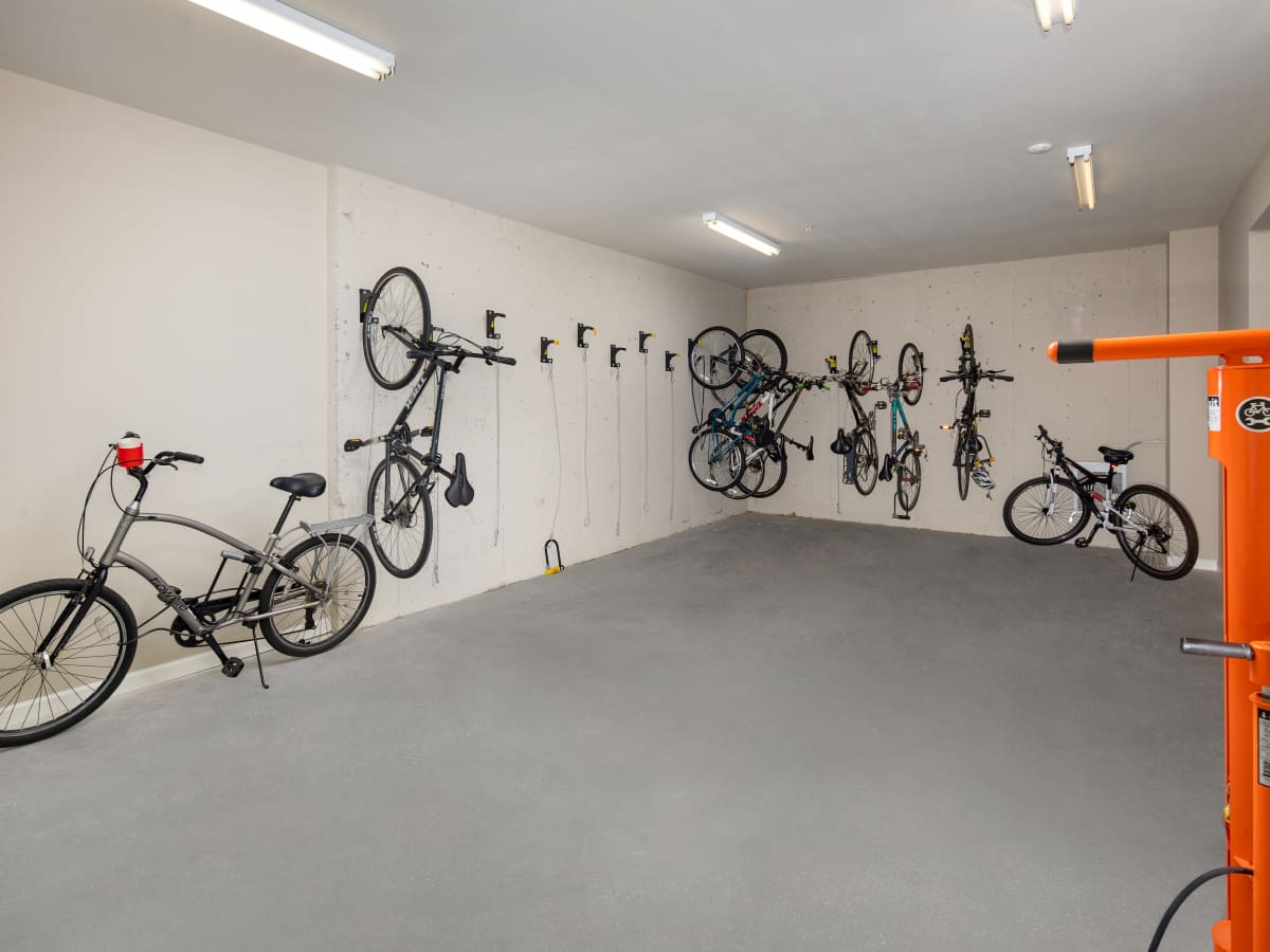 Gated bicycles mounted on wall hooks in garage at Ardmore & Twenty Eighth in Atlanta, Georgia