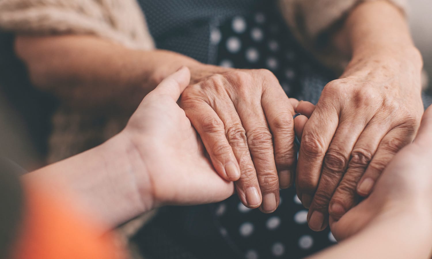 A caretaker holding a resident's hands at Sandpiper Village in Mt. Pleasant, South Carolina